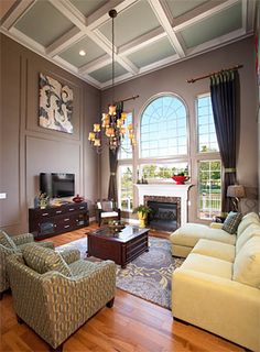 a living room filled with furniture and a fire place in the middle of a room