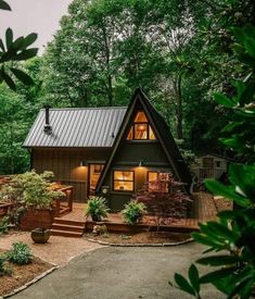 a small cabin in the woods with steps leading up to it's front door