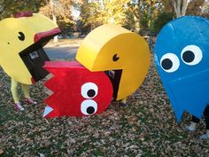 three paper mache characters are standing in the grass with their mouths open and eyes wide