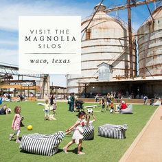 children and adults playing in the grass near large silos with text overlay reading visit the magnolia sloss waco, texas