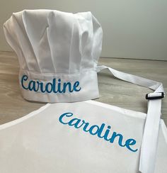 a chef's hat with the name cardine on it and a white apron