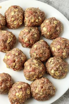 a white plate filled with meatballs on top of a table