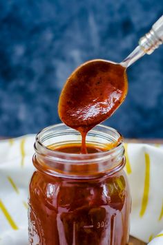 a spoon full of jam on top of a wooden table