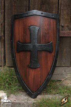 a wooden shield with a cross on it