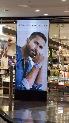 an advertisement for tommy hilfiger in a mall