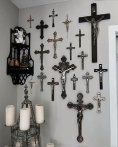 the wall is decorated with crosses and candles