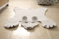 a cat shaped rug on the floor in a room