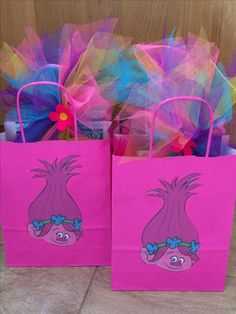 two pink bags with cartoon characters on them