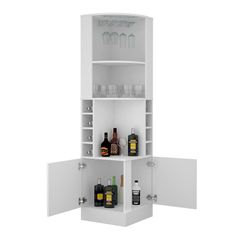 a white cabinet with bottles and glasses on it's shelves in front of a wall