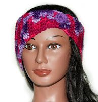 a female mannequin head wearing a pink and purple knitted beanie hat