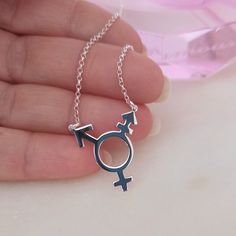 P R I D E * N E C K L A C E *T R A N C G E N D E R * S Y M B O L *  Sterling Silver Best friend gift. Valentines day gift idea. Best gift. ♥Introducing our stunning Transgender Symbol Pride Necklace! A true symbol of pride, equality, and inclusivity, this necklace allows you to showcase your support and solidarity with the transgender community.  ♥This LGBT Necklace is so light...make it your everyday staple. Style: *Handmade jewery * Minimalist jewelry * Rainbow pride * Transgender symbol * Charm necklace * Trans pride necklace *  P R O D U C T   D E S C R I P T I O N ♥We are so sure you will love our quality jewellery.  ♥Our jewellery is made from Sterling silver and is covered in real 18 Karat Gold.  Featuring a 20x20mm Transgender Necklace with an adjustable 16 to 18 inch chain. Sterli Transgender Symbol, Pride Equality, Pride Symbol, Pride Necklace, Symbol Necklace, Pride Gifts, Best Friend Gift, Gold Plated Jewelry, Minimalist Jewelry