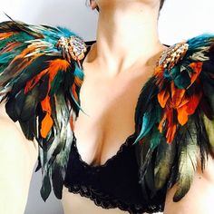 a woman wearing a bra with feathers on it