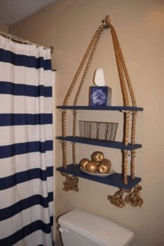 a bathroom with blue and white decor on the wall, toilet and shower curtain in the background