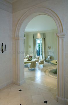 an archway leads to the living room and dining area