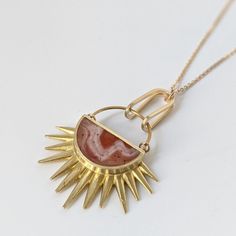 This stylish Full Of Hope necklace is made of brass and hand painted resin, creating a unique piece of jewelry with lots of movement yet remaining lightweight. The 18 inch gold-plated chain adds the finishing touch. Gold Agate Jewelry With Large Pendant, Gold Wire-wrapped Agate Jewelry, Gold Agate Wire Wrapped Necklace, Gold Agate Wire Wrapped Jewelry, Unique Yellow Gold Wire Wrapped Necklaces, Unique Yellow Gold Wire Wrapped Necklace, Gold Agate Jewelry With Adjustable Chain, Unique Carnelian Necklace With Large Pendant, Gold Carnelian Pendant Necklace