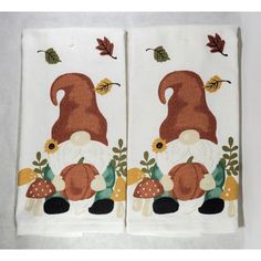 two tea towels with gnomes and mushrooms on them, one is brown and the other is white