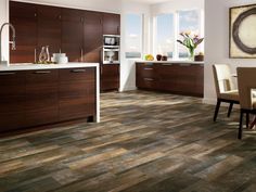 a large kitchen with wooden floors and white walls