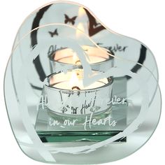 a glass candle holder with two candles in it and the words i am our hearts written on it