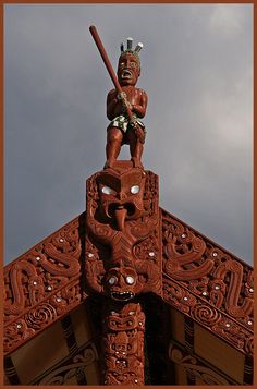 a wooden statue on top of a building