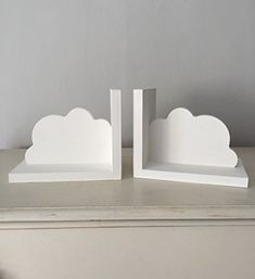 two white bookends sitting on top of a table