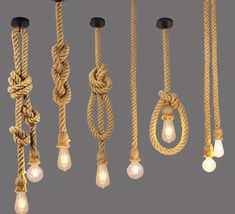 several ropes and lights hanging from the ceiling in different positions, with one light turned on