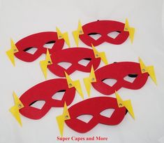 a bunch of red and yellow masks with lightning bolts on them