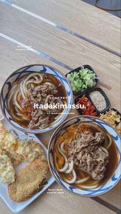 three bowls filled with food on top of a wooden table