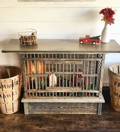 a wooden table with two baskets and a toy truck on top