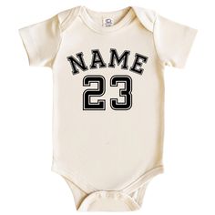 Custom Name And Number Bodysuit Best Newborn Gift, Custom Bodysuit, Personalized Baby Gift, Baby Gift, Personalized Name Bodysuit Organic Cotton Bodysuits: Where Softness Meets Design Hello there! We're BestieFL, and we create organic cotton bodysuits, carefully designed with your little one in mind. These tiny garments are the perfect choice for your baby's comfort and style.  Organic Cotton: Our bodysuits are made from the finest organic cotton fabric. They offer softness without harming your baby's delicate skin and are known for their breathability. Digital Print Designs: Each bodysuit is adorned with colorful and adorable patterns using digital printing technology. You can choose from animal figures, plant motifs, or fun patterns. Sizes for Different Age Groups: We offer size options Fun Patterns, Cotton Bodysuit, Personalized Baby Gifts, Animal Figures, Organic Cotton Fabric, Hello There, Newborn Gifts, Kids Tops, Cool Patterns