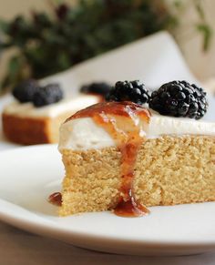 a piece of cake on a plate with berries