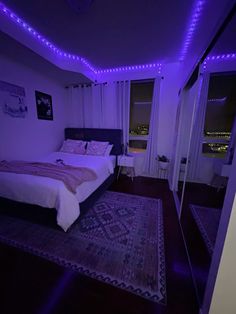 a bed room with a neatly made bed and purple lights