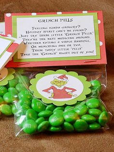 some green candies are sitting on the ground next to a bag with candy in it