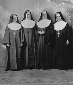 an old photo of three women dressed in nun suits and holding hands behind their backs