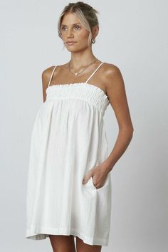 Throw on the Lucy White Shift Dress and head to your next getaway in style! Woven tone on tone striped fabric falls from spaghetti straps into a straight neckline with smocked detail and shift bodice DETAILS & CARE Cotton. Machine wash cold. Imported. White Linen Dress Summer, Lucy White, Woman Streetwear, Vintage Summer Outfits, White Shift Dress, Cute White Dress, Summer School Outfits, White Shift Dresses, Modest Summer Outfits