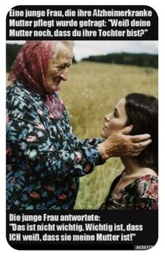 an older woman is touching the face of another old woman in a field with grass