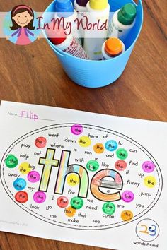 a blue bucket filled with crayons next to a printable word name game