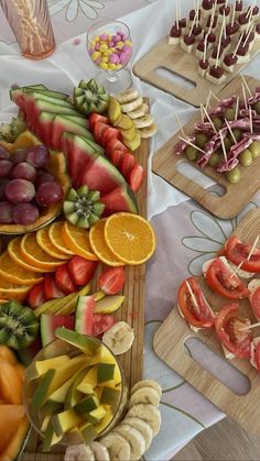 there are many different types of fruits and vegetables on the trays with toothpicks