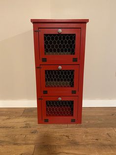 a red cabinet with three drawers on top