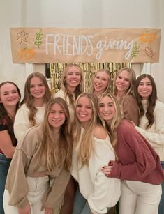 a group of young women standing next to each other in front of a friends giving sign