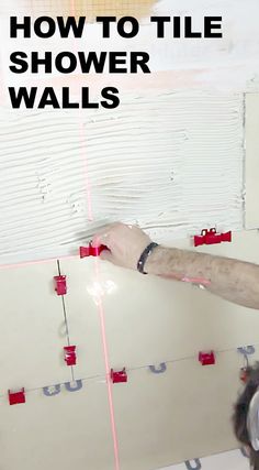 a man working on a shower wall with the words, how to tile shower walls