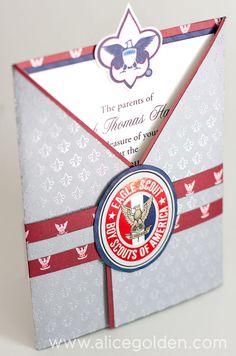 an origami style envelope with a badge on the front and bottom, decorated with red white and blue stripes