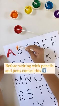 someone writing with pencils and pens comes this letter from the alphabet on a sheet of paper