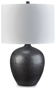 a black table lamp with a white shade on the base and a light in front of it