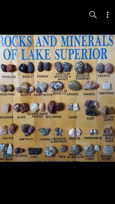 the rocks and minerals of lake superioror are displayed on a wooden board with blue lettering