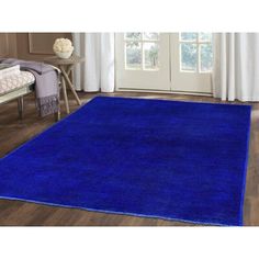 a bright blue rug in a living room