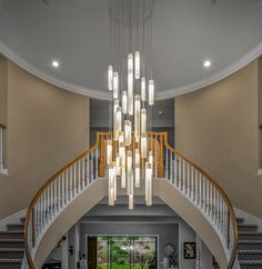 a large foyer with chandelier and stairs leading up to the second floor area