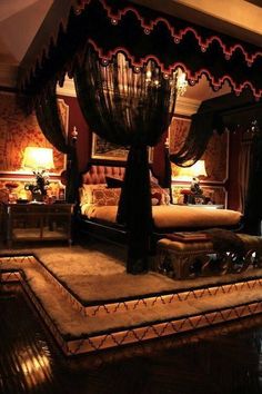 a bedroom with a canopy bed and chandelier on the ceiling is lit up