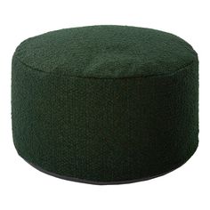 a green round ottoman sitting on top of a white floor