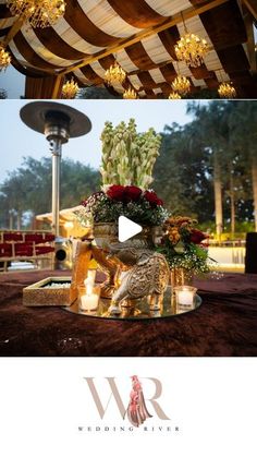 an outdoor wedding setup with flowers and candles on the table, and in front of a canopy that has lights hanging from it