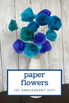 blue paper flowers in a white vase with the words paper flowers 1st anniversary gift on it